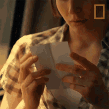 Looking At A Photo Natalie Welsh GIF - Looking At A Photo Natalie Welsh National Geographic GIFs