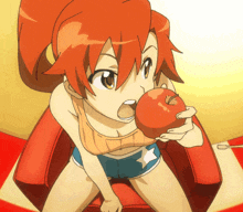 a girl with red hair is sitting on a red chair eating an apple