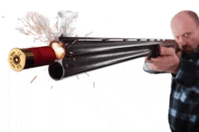 a man is holding a shotgun with a shotgun shell flying out of it .
