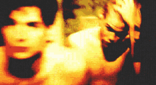 a pixelated image of a man holding a knife in front of a woman 's face