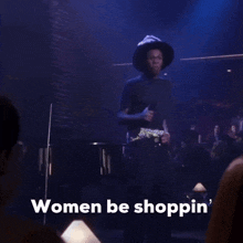 a man singing into a microphone with the words " women be shoppin " on the bottom