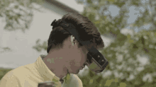 a man is wearing a virtual reality headset while standing in front of a building .