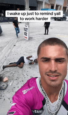 a man taking a selfie with a sign that says valet here