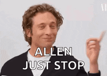 a man is making a funny face and saying `` allen just stop '' with his finger .