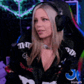 a woman wearing headphones and a jacket that says pontiac on the sleeves