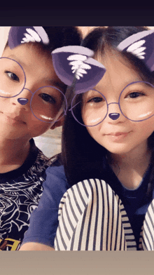 a boy and a girl wearing purple cat ears