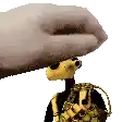 a hand is holding a stuffed animal with a backpack on it .