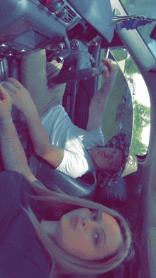a man and a woman are sitting in a car and the man has a tattoo on his arm that says " i love you "