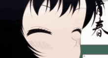 a close up of a girl 's face with her eyes closed and a sign in the background .