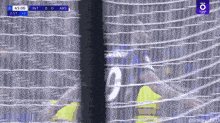 a soccer player wearing a number 9 jersey is behind a net