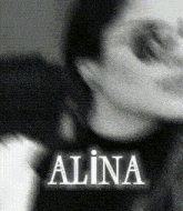 a black and white photo of a woman with the name alina above her