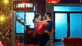 a man is carrying a woman in his arms in a room .