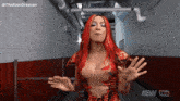 a woman with red hair is standing in a hallway .