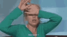 a person wearing a green glove is making a hand gesture with their fingers .