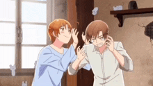 two anime characters are standing next to each other in a room and one is making a funny face .