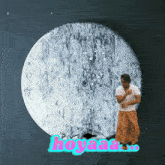 a man standing in front of a full moon with the word hoyaaa written in pink