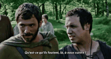 a man with a beard is talking to another man in a foreign language