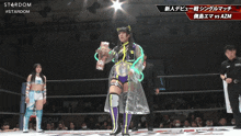 a female wrestler stands in a ring with a stardom logo in the background