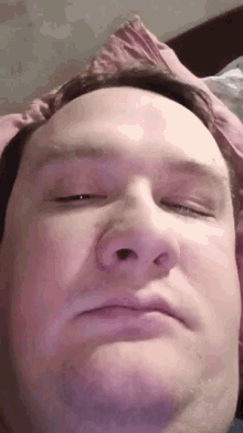 a close up of a man 's face with his eyes closed and his nose visible