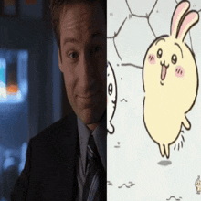 a man in a suit and tie smiles next to a drawing of a rabbit