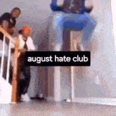 a blurry picture of people on a staircase with the words august hate club on the bottom right