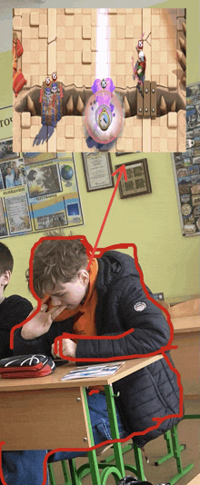 a boy is sitting at a desk in front of a wall with a poster that says ' to ' on it