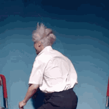 a man with gray hair is using a walker .