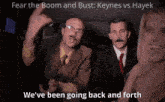 a man with a mustache and glasses says " we 've been going back and forth " in front of a woman