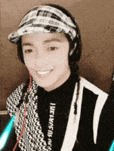 a woman wearing headphones and a plaid hat has a shirt that says influence on it