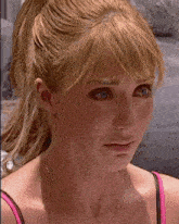 a woman with blonde hair and blue eyes is crying