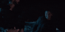 a close up of a person 's face with glowing eyes in the dark