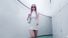 a woman in a white dress with purple hair and sunglasses