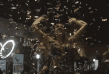 a woman in a dress is surrounded by confetti with the letter c visible in the background