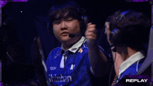 a man wearing headphones and a shirt that says shinhan