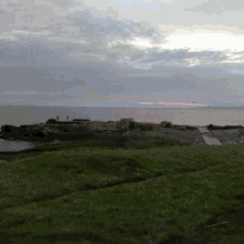 a view of the ocean from a grassy area