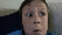 a pixelated image of a woman 's face with a blue shirt