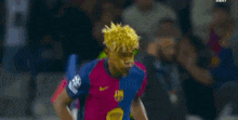 a soccer player with yellow paint on his face is running on the field during a game .