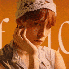 a woman wearing a white crocheted hat and a gray shirt