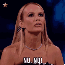 a woman with blonde hair and a necklace says " no no "