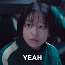 a girl in a green jacket says " yeah "