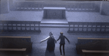 a man and a woman are holding hands in a church