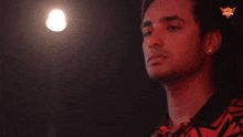 a man 's finger is pointing at a light that says wow on the bottom