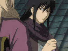 a man with long black hair and a purple scarf around his neck