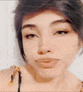 a close up of a woman 's face with a slight smile on her face