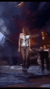 a woman singing into a microphone on a stage