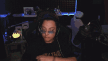 a woman wearing headphones and a shirt that says " may the force be with you "