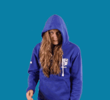 a woman wearing a blue sweatshirt that says ucsd on the front