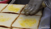 a person is spreading butter on a slice of bread