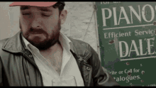 a man standing in front of a sign that says piano
