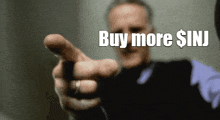 a man is pointing at the camera with the words buy more $ inj written above him